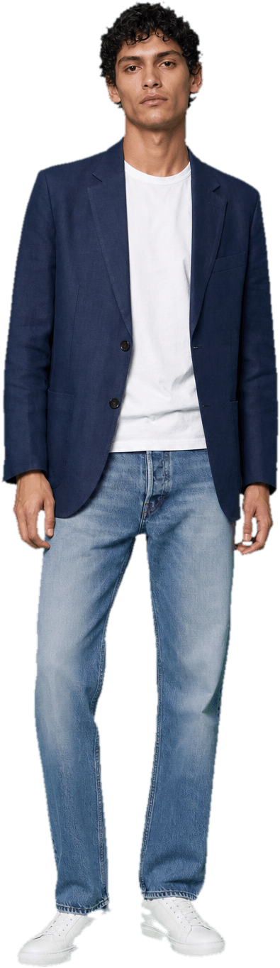 An unstructured navy linen blazer thrown over a plain white t-shirt, with faded straight-leg blue jeans and white leather sneakers