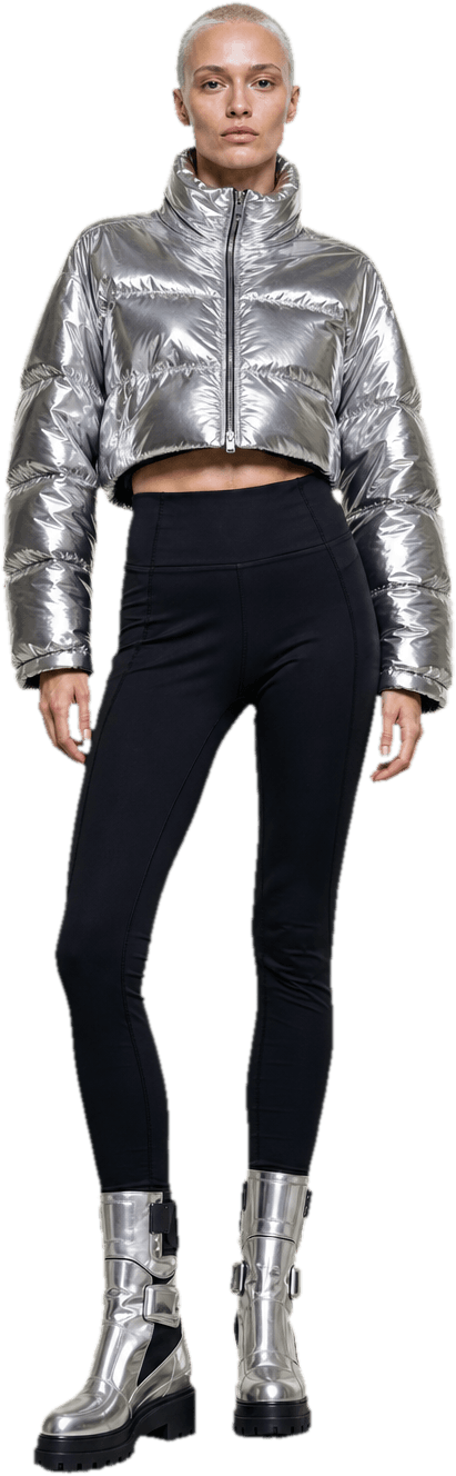 A cropped chrome-silver puffer jacket with a high collar over black technical leggings, with heavy silver-panelled boots