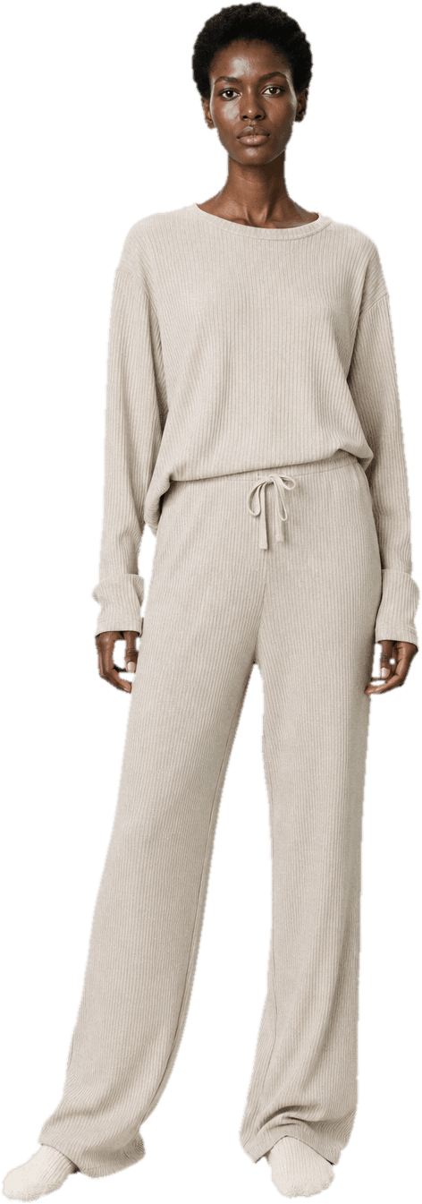 A soft oatmeal ribbed lounge set, a boxy long-sleeve top and matching wide drawstring trousers, with thick cream socks