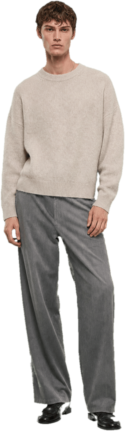 A boxy oatmeal mohair sweater with dropped shoulders over wide-leg washed grey trousers, with plain black leather loafers