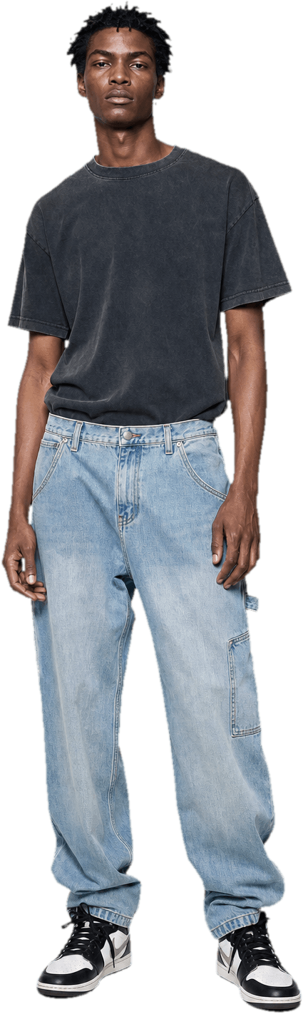 A boxy washed graphic t-shirt tucked into baggy light-wash carpenter jeans, with a chunky pair of retro basketball sneakers